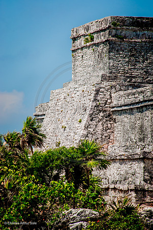 East wall of El Castillo above palm trees, Maya ruins at Tulum